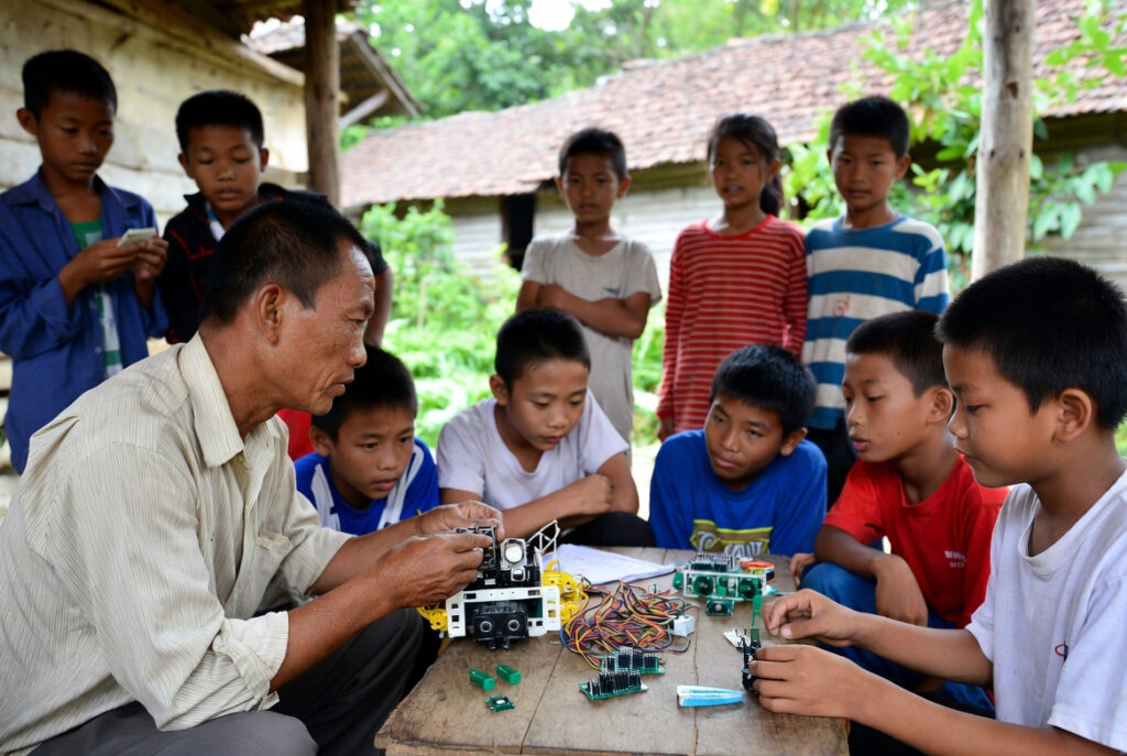 village teacher coaching students-1